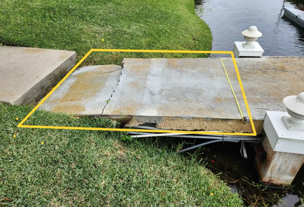 Concrete pier slab section outlined in yellow marking to show demolition and cutting area