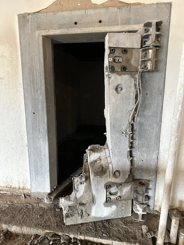 Commercial bank vault door removal process with door partially cut and dismantled