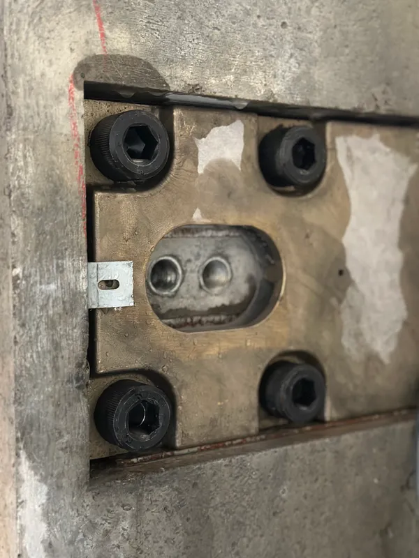 Exposed vault door hinge and pivot mechanism during controlled bank vault demolition